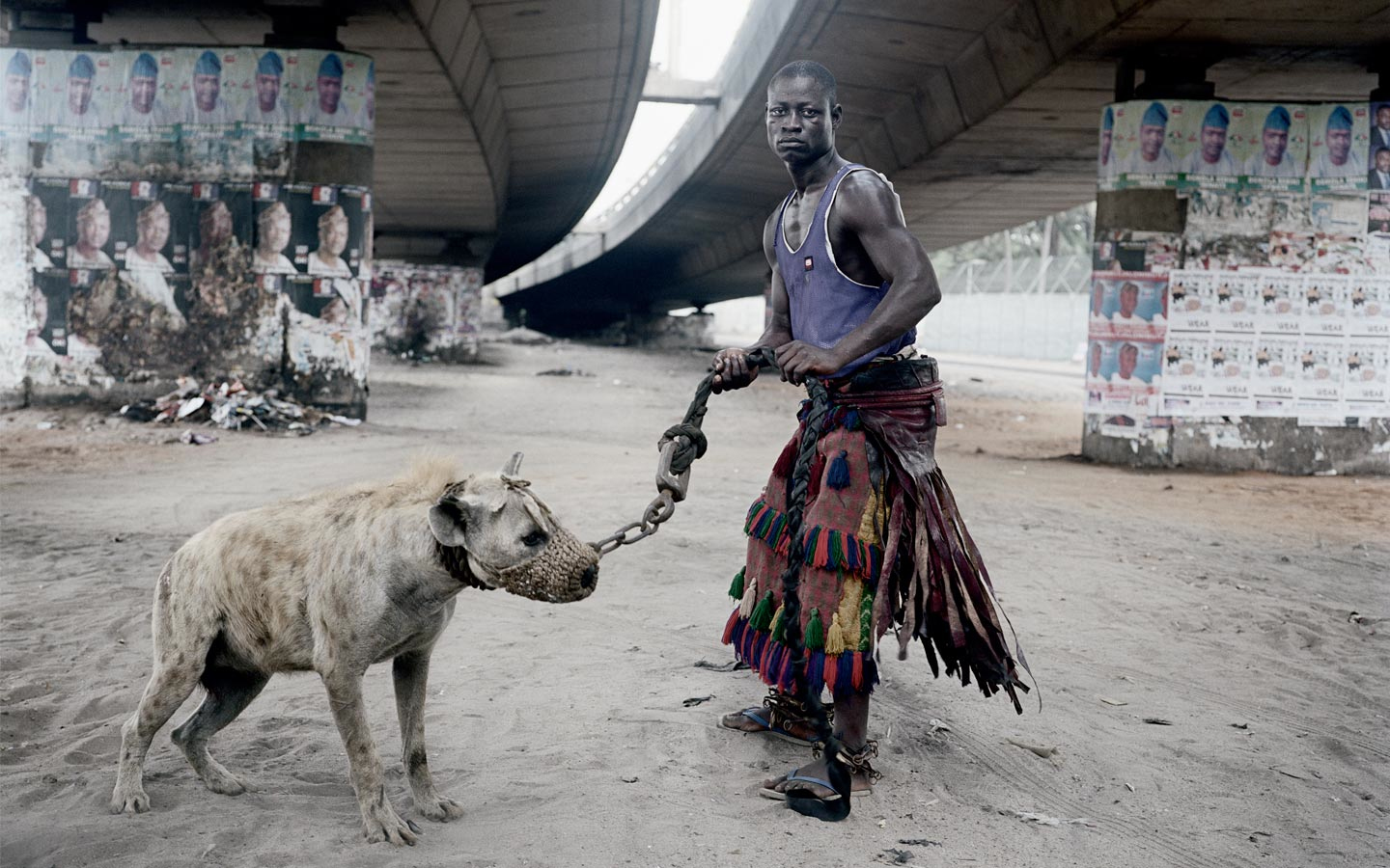 Pieter Hugo (South African, b. 1976) Abdullahi Mohammed with Mainasara, Lagos, Nigeria (from the series The Hyena and Other Men), 2007. Digital c-print, 43 x 44 in. Museum purchase, Wachenheim Family and Art Fund. M.2008.24 Pieter Hugo (South African, b. 1976) Abdullahi Mohammed with Mainasara, Lagos, Nigeria (from the series