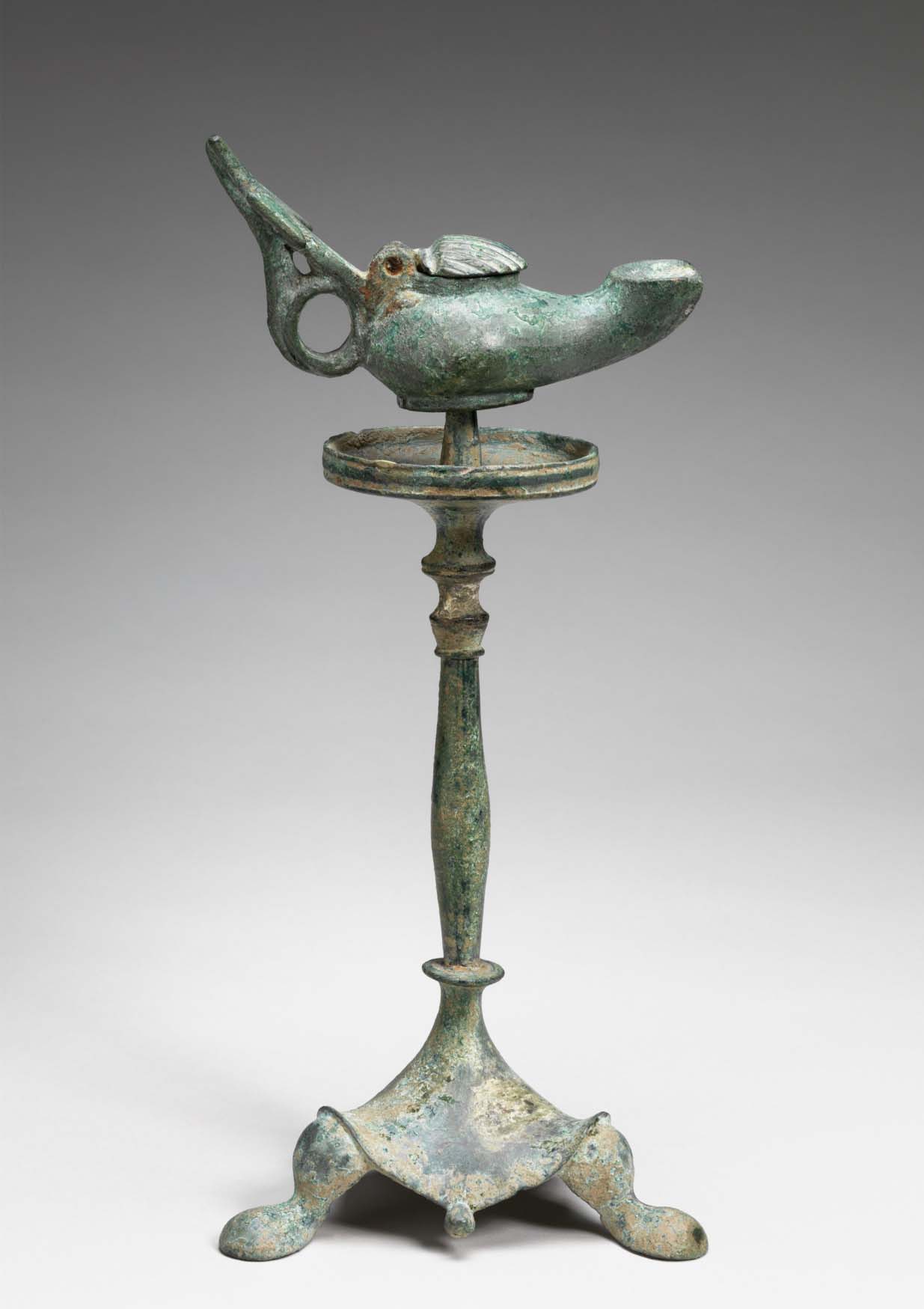 Byzantine. Oil Lamp with Cross and Scallop Shell Cover on Stand, c. 5th–6th century. Bronze, 2 7/8 x 2 1/16 x 5 1/8 in. Gift of the son and daughters of Charles Bolles-Rogers, Class of 1907: Frederick Van D. Rogers, Mary Rogers Savage, and Nancy Rogers Pierson, 75.43.41