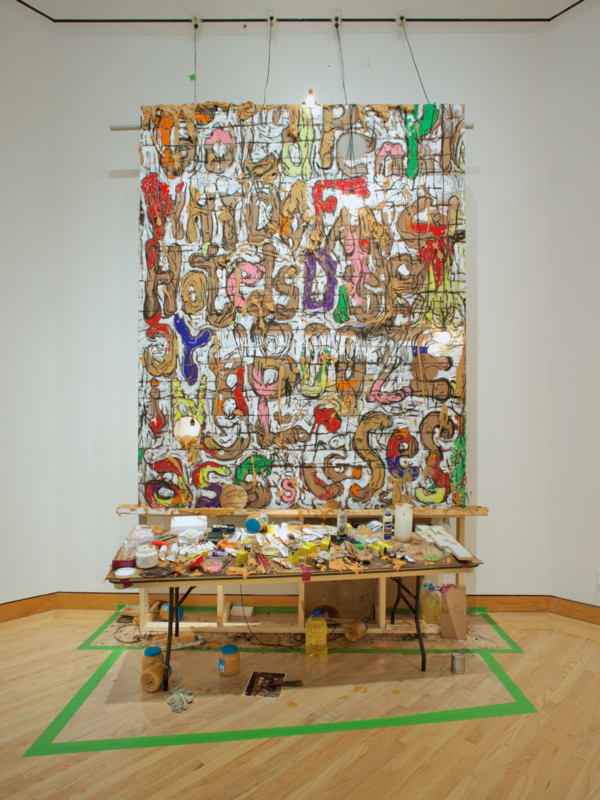 William Pope.L (American, b. 1955) Mudder of Excess Part B, 2017 Peanut butter, vegetable oil, oil paint, acrylic, charcoal, graphite, joint compound, and tape on masonite with light bulbs, electrical cords, wood, and hardware Courtesy of the artist and Mitchell-Innes & Nash and Susanne Vielmetter Los Angeles Projects