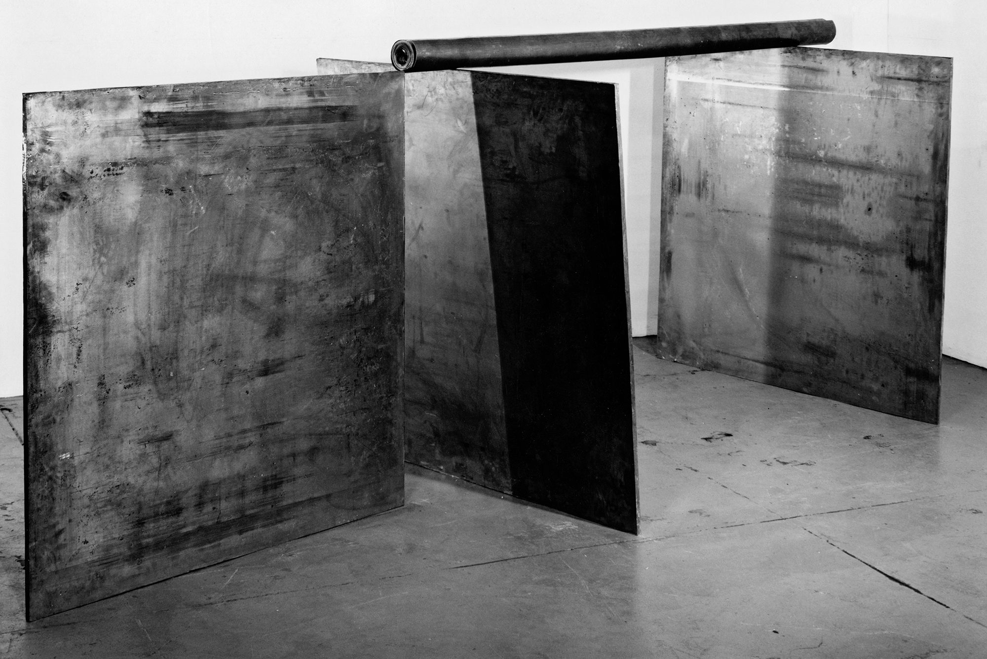 Richard Serra (American, b. 1939), 1-1-1, 1969. Lead, three plates: each: 48 x 48 x 1 in., pole: 84 in. long, 4 in. diameter. Photo by Peter Moore. Collection of the artist.